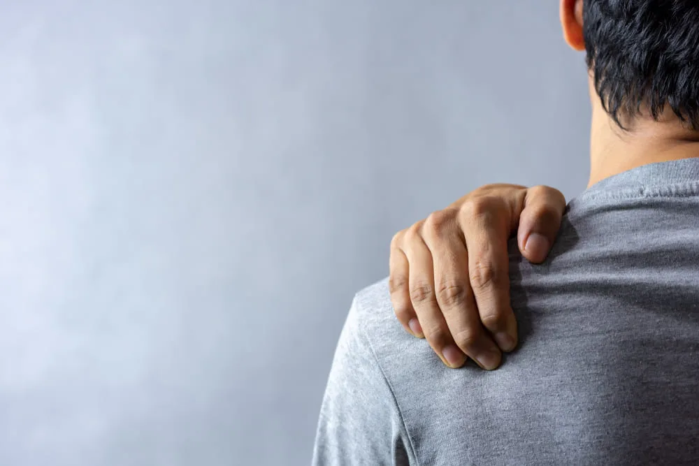 Man's shoulder with another person's hand resting on it