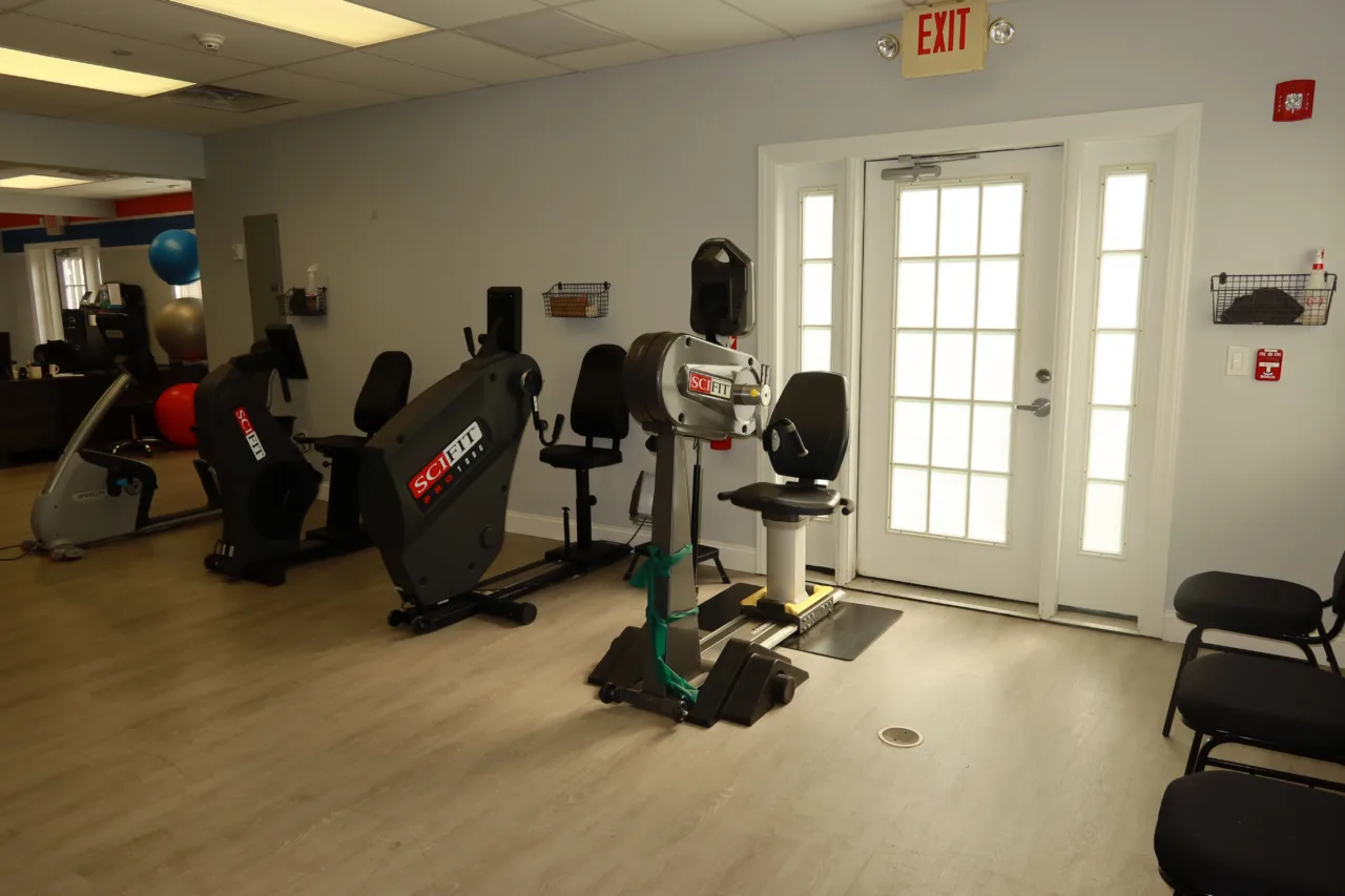Cardio machines beside the entrance doors, with exercise balls at the far end