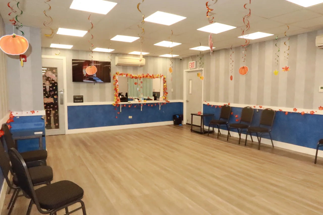 Waiting room decorated for Halloween, with rows of chairs along the walls and the reception desk beyond