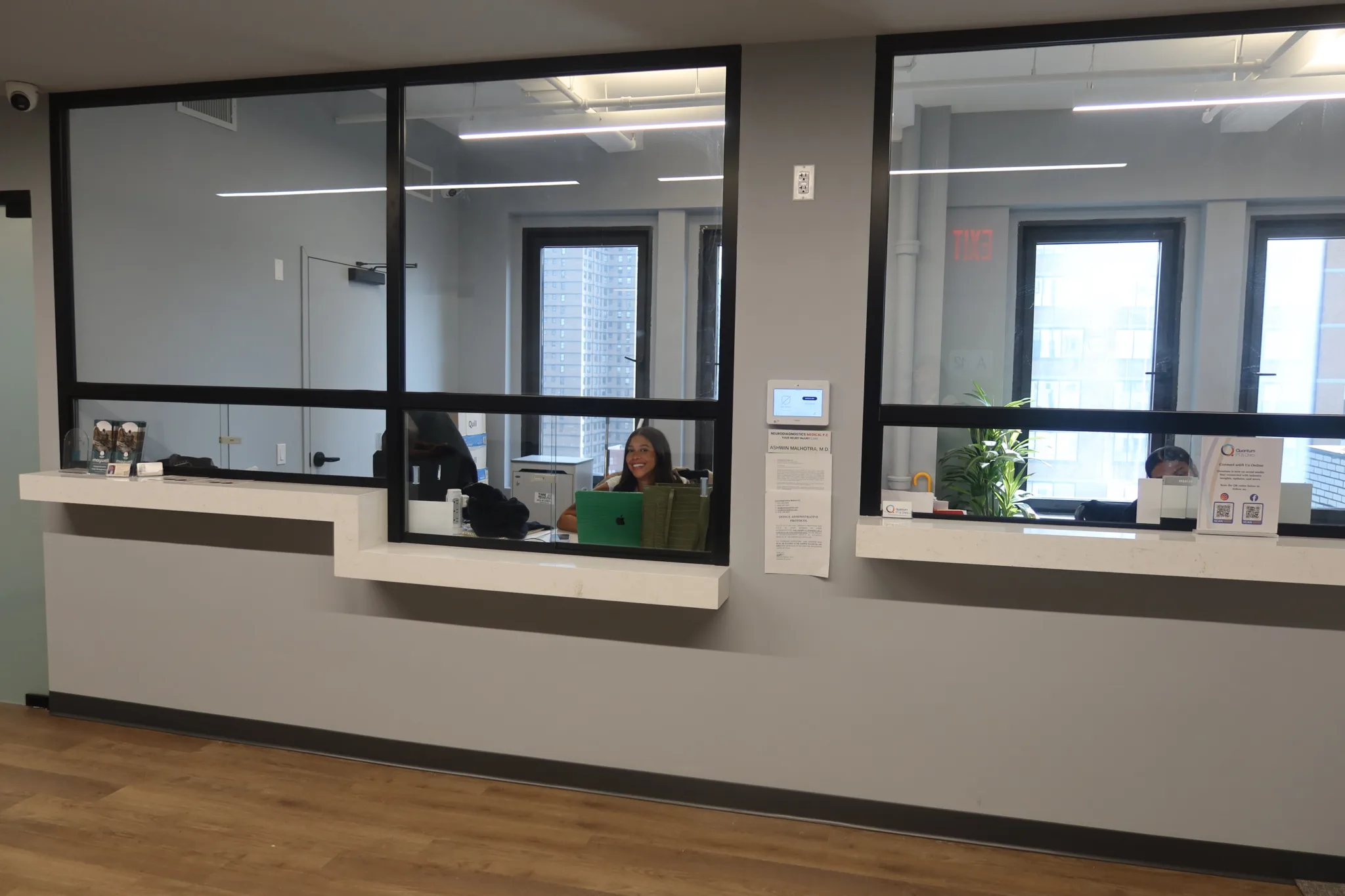 Reception window looking through to the front office, with the waiting area in front