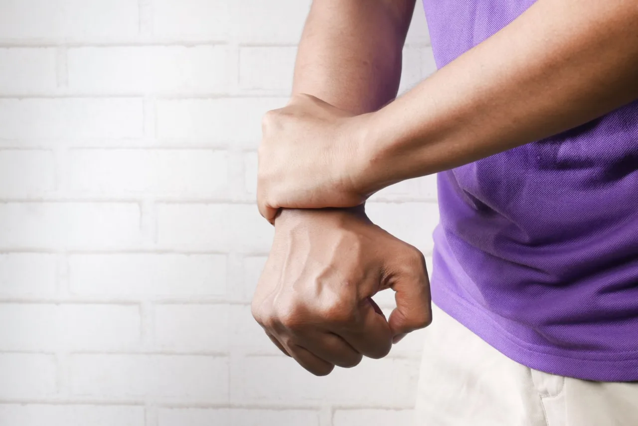 Person holding a painful wrist