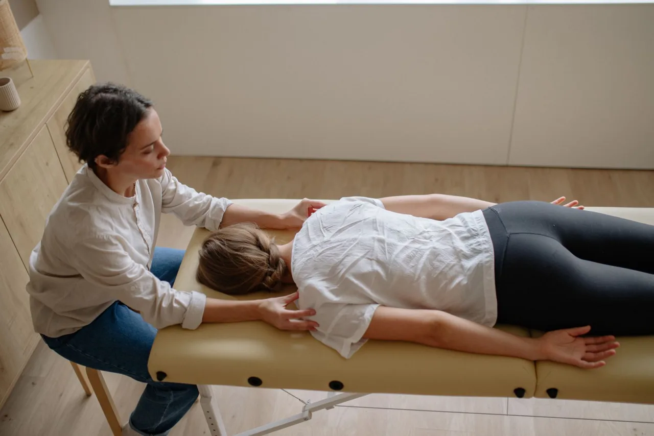 Chiropractor adjusting a patient’s back on a treatment table