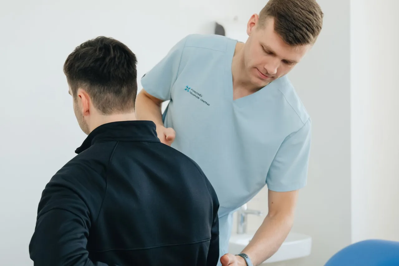 Physiotherapist treating a patient’s back in a treatment room